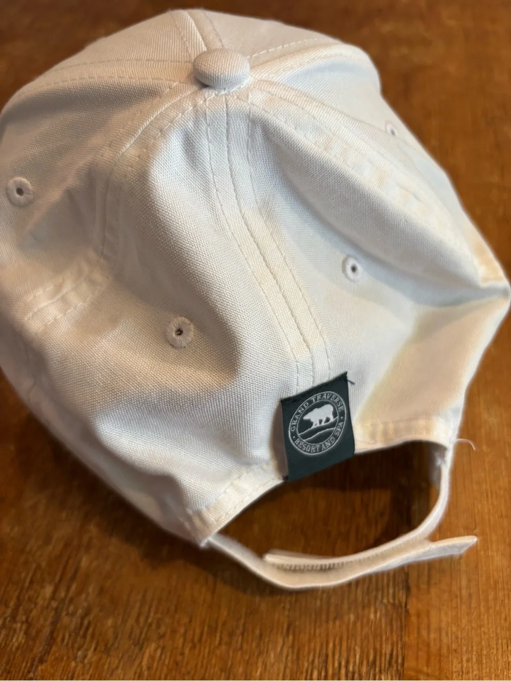 Men’s white golf hat with Grand Traverse Resort logo and year 1985 in dark green